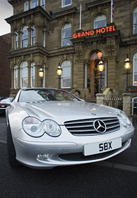 Mercedes SL with the number plate 58X outside the Grand Hotel